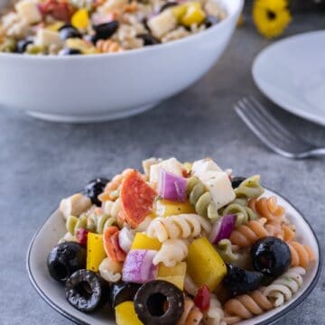 This easy pasta salad with pepperoni is quick and delicious! It’s great for dinner with the family or a party! #pastasalad #partyrecipe #bbq #atablefullofjoy #italianpastasalad #antipasta #sidedish #summer