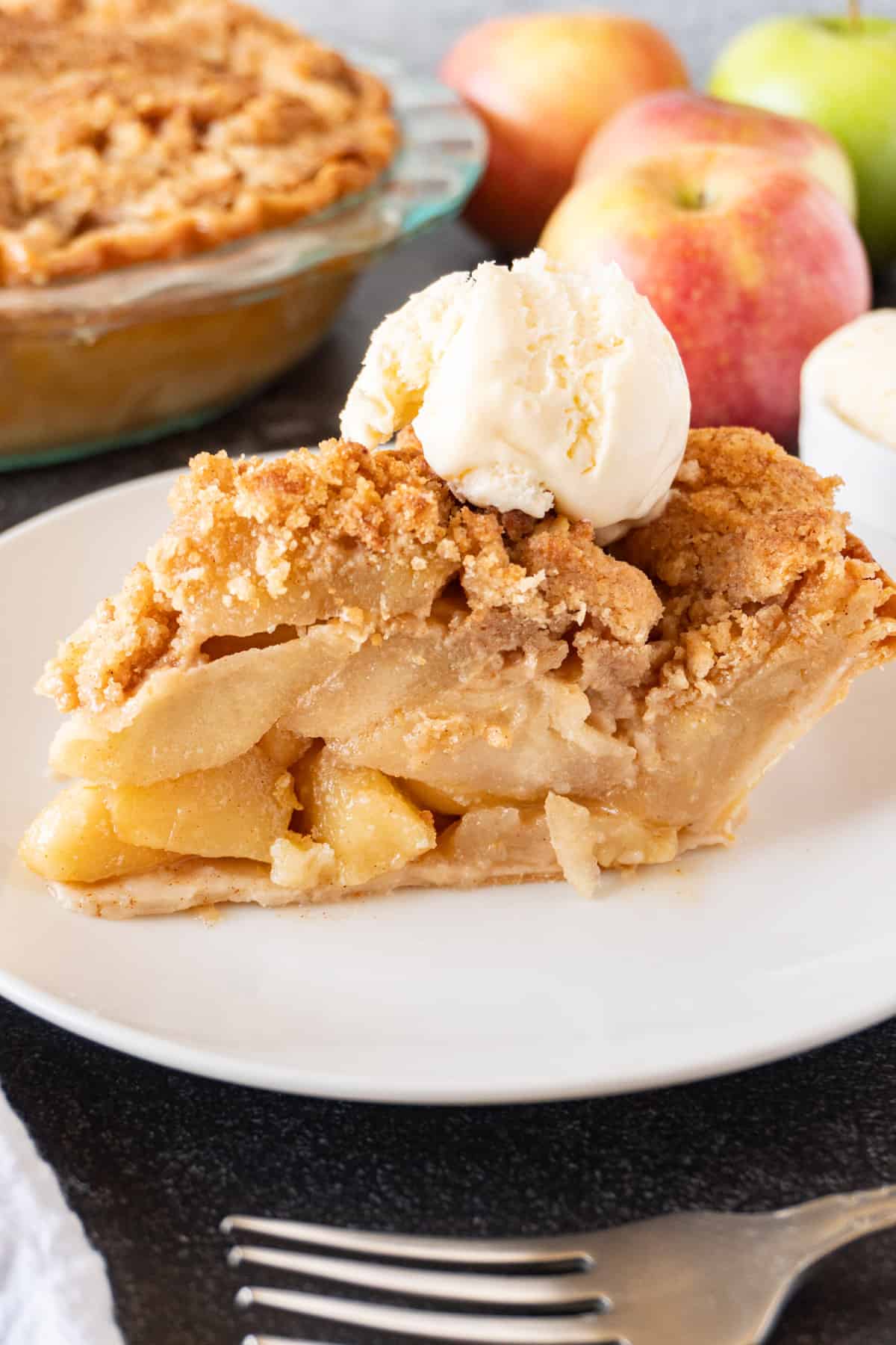 slice of apple pie with ice cream scoop on top