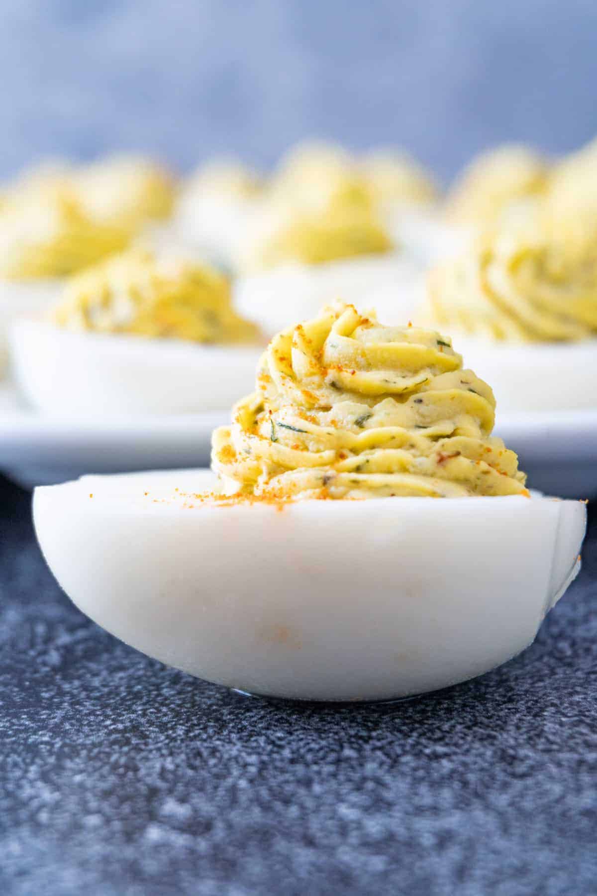 Best Deviled Eggs Recipe- these deviled eggs are full of flavor, quick to make and perfect every time! A crowd pleaser at every holiday and the perfect snack! close up of deviled eggs