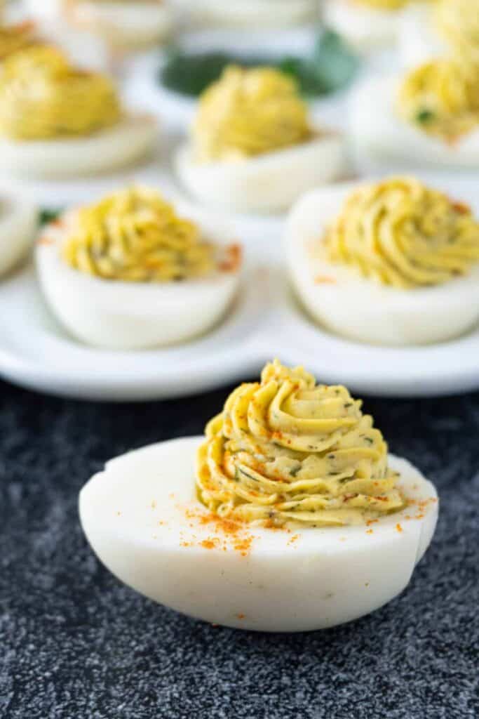 Deviled egg with platter in background