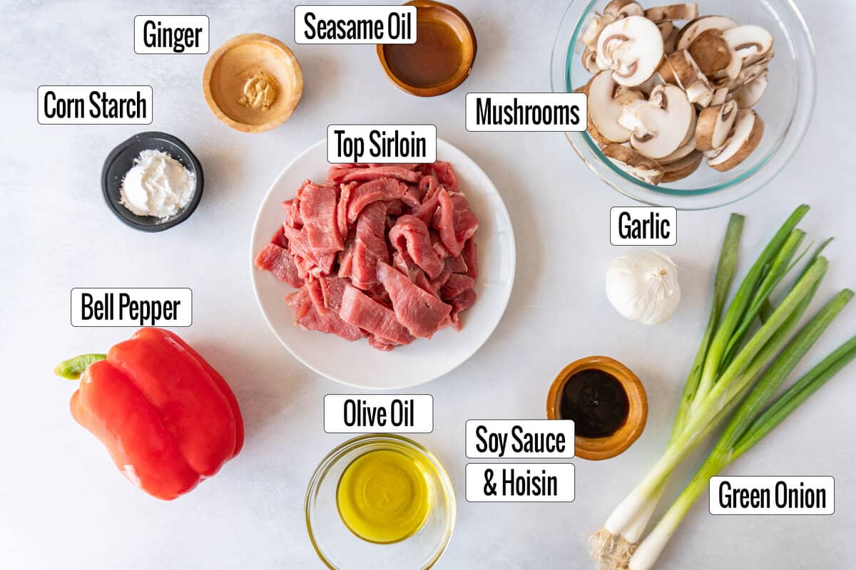 ingredients laid out : top sirloin., corn starch, olive oil, mushrooms, bell pepper, garlic, green oinion, soy sauce, hoisin, seasme oil