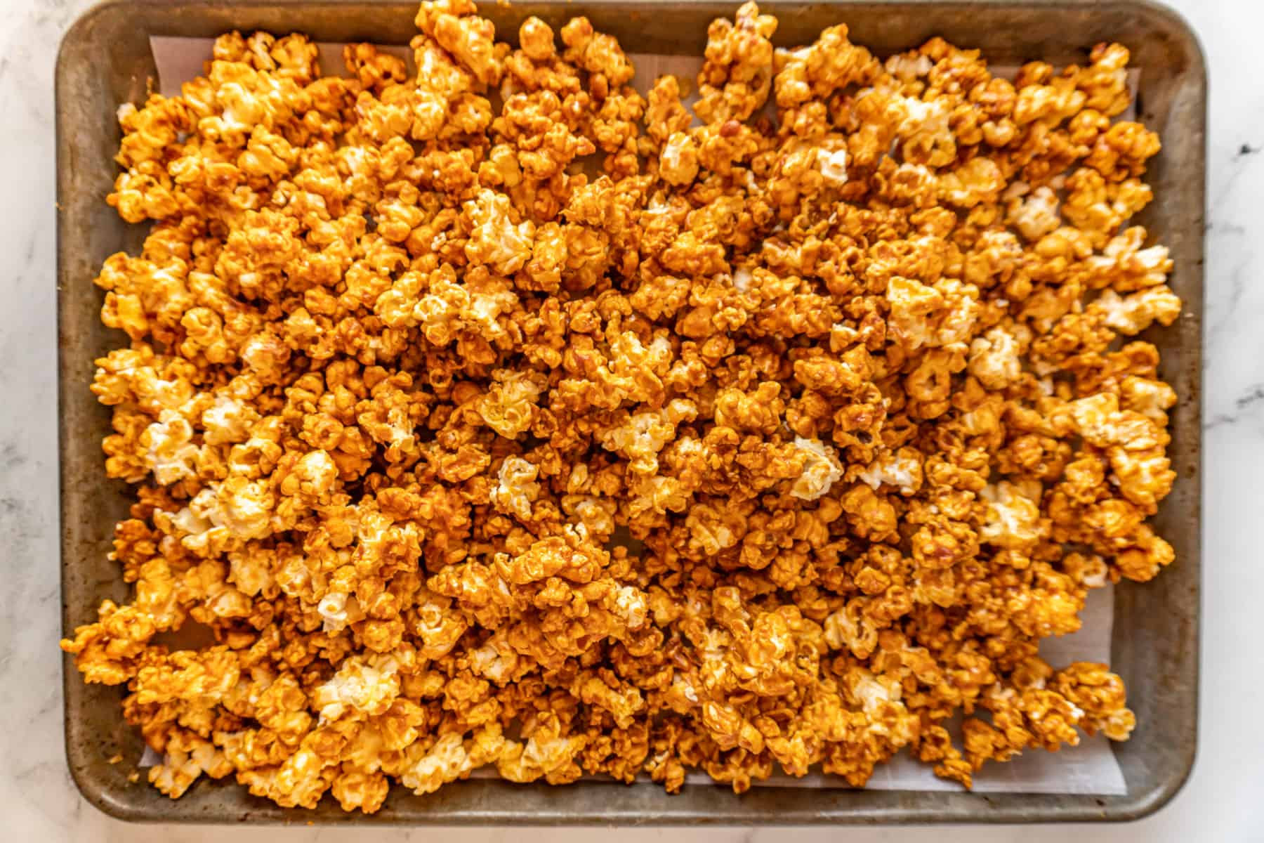 buffalo popcorn on baking sheet