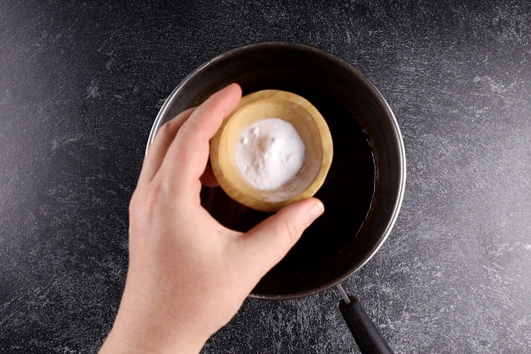 stirring in baking soda to caramel