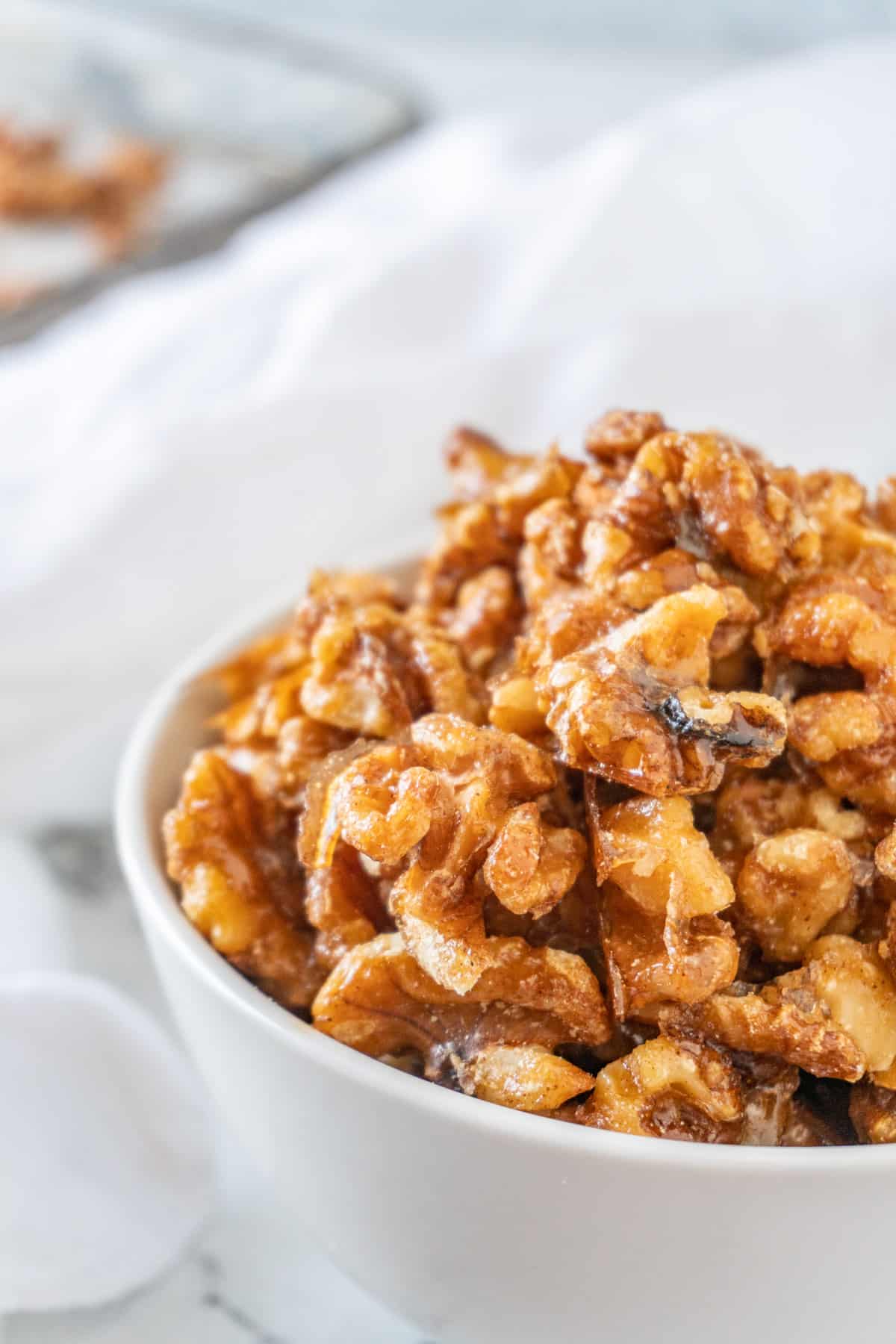 candied walnuts in white bowl close up