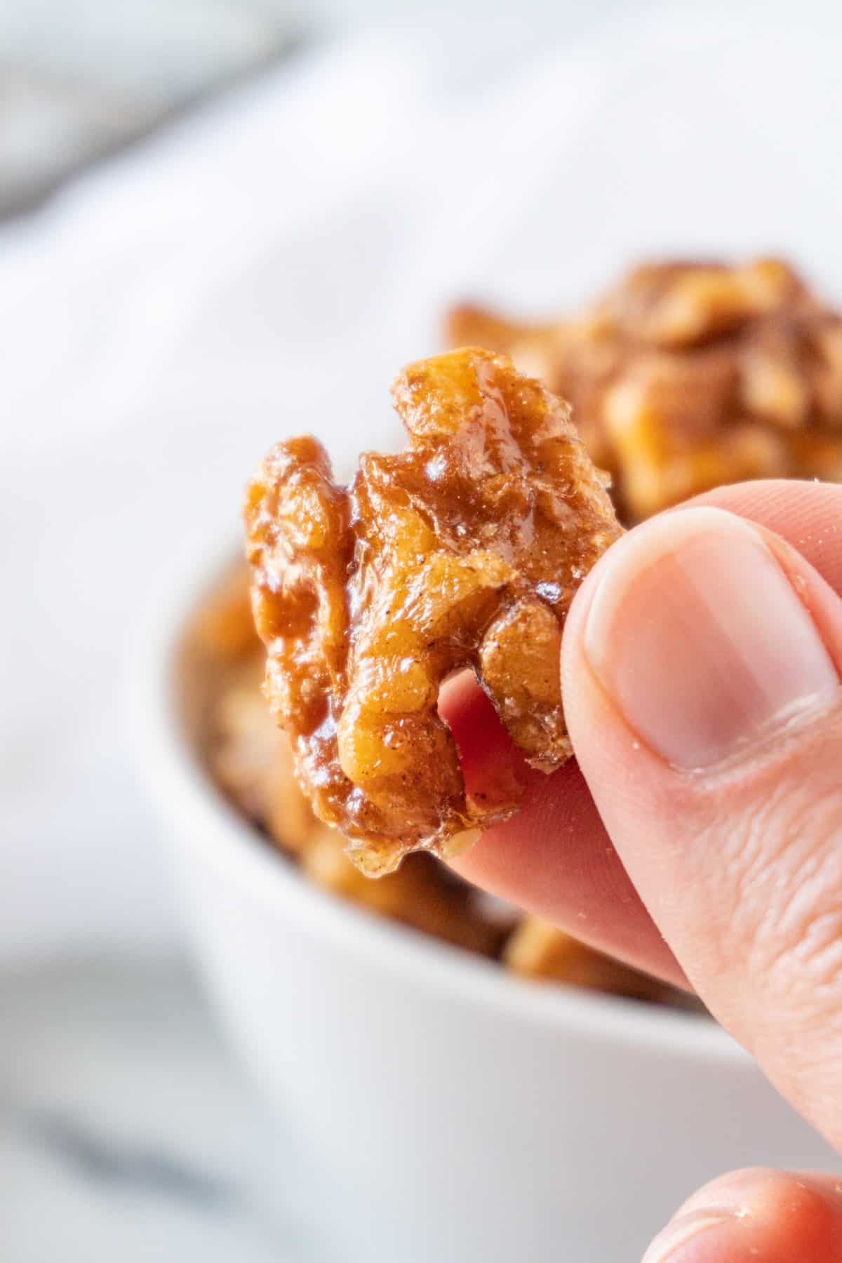 holding a candied walnuts