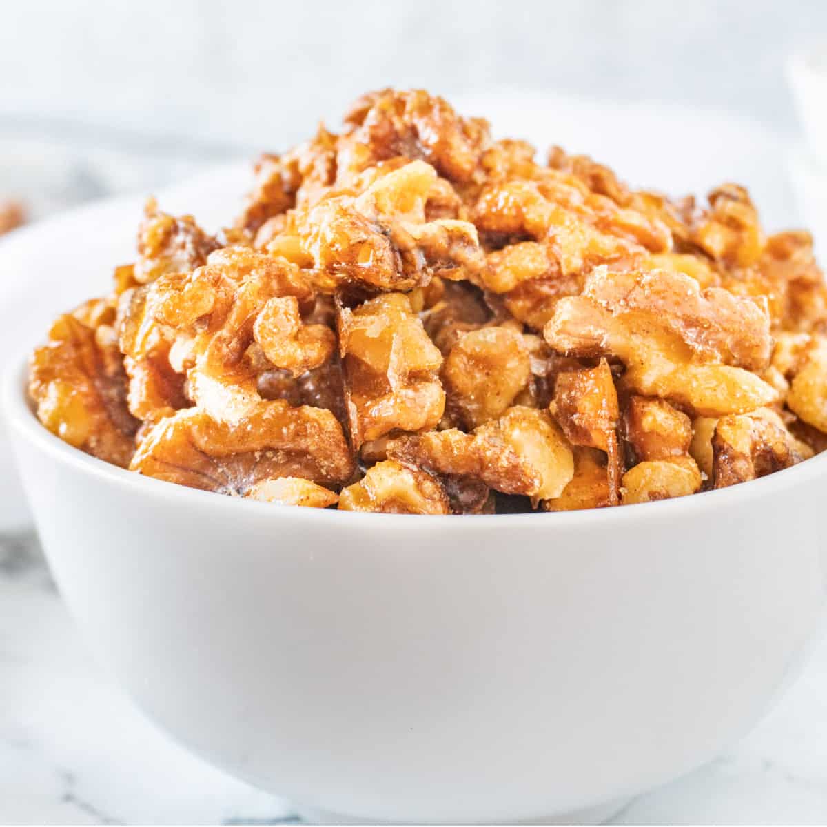 candied walnuts in white bowl featured image
