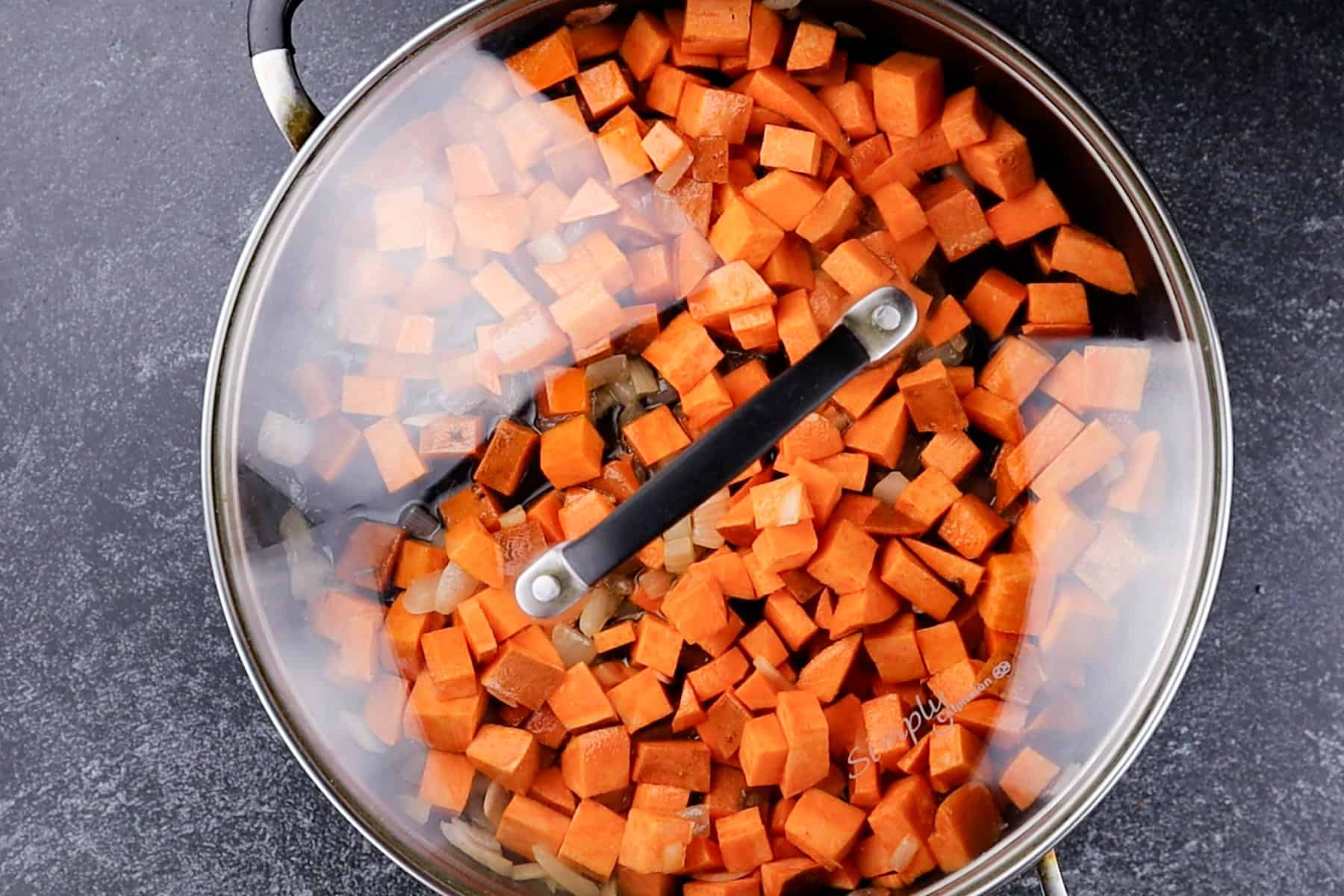 lid on pan with sweet potatoes in it