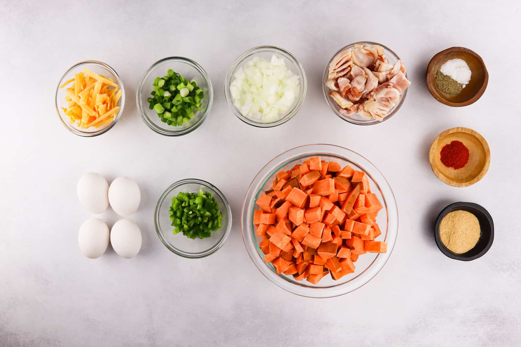 sweet potato breakfast skillet ingredients in bowls