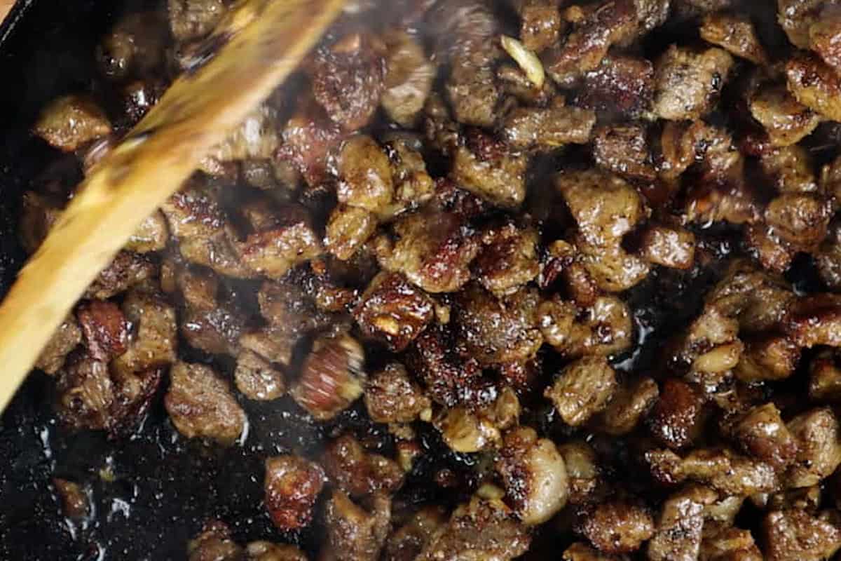 cooking steak in cast iron pan