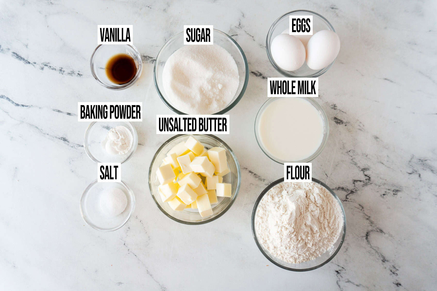 Strawberry Shortcake cupcake ingredients in individual bowls and labeled.