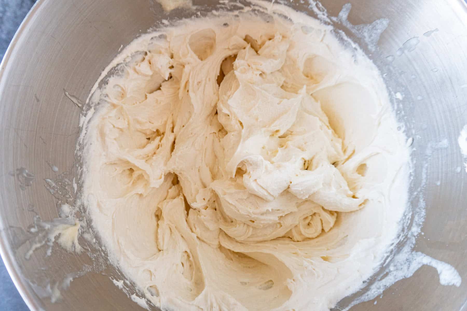 strawberry shortcake cupcake batter mixed in a metal bowl.