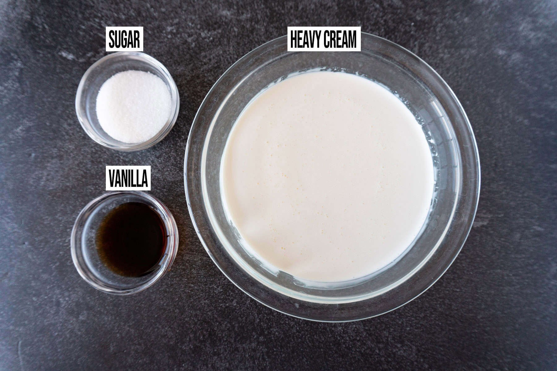 whipped cream frosting ingredients in individual bowls and labeled.
