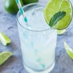 Glass of limeade with lime wedge and straw