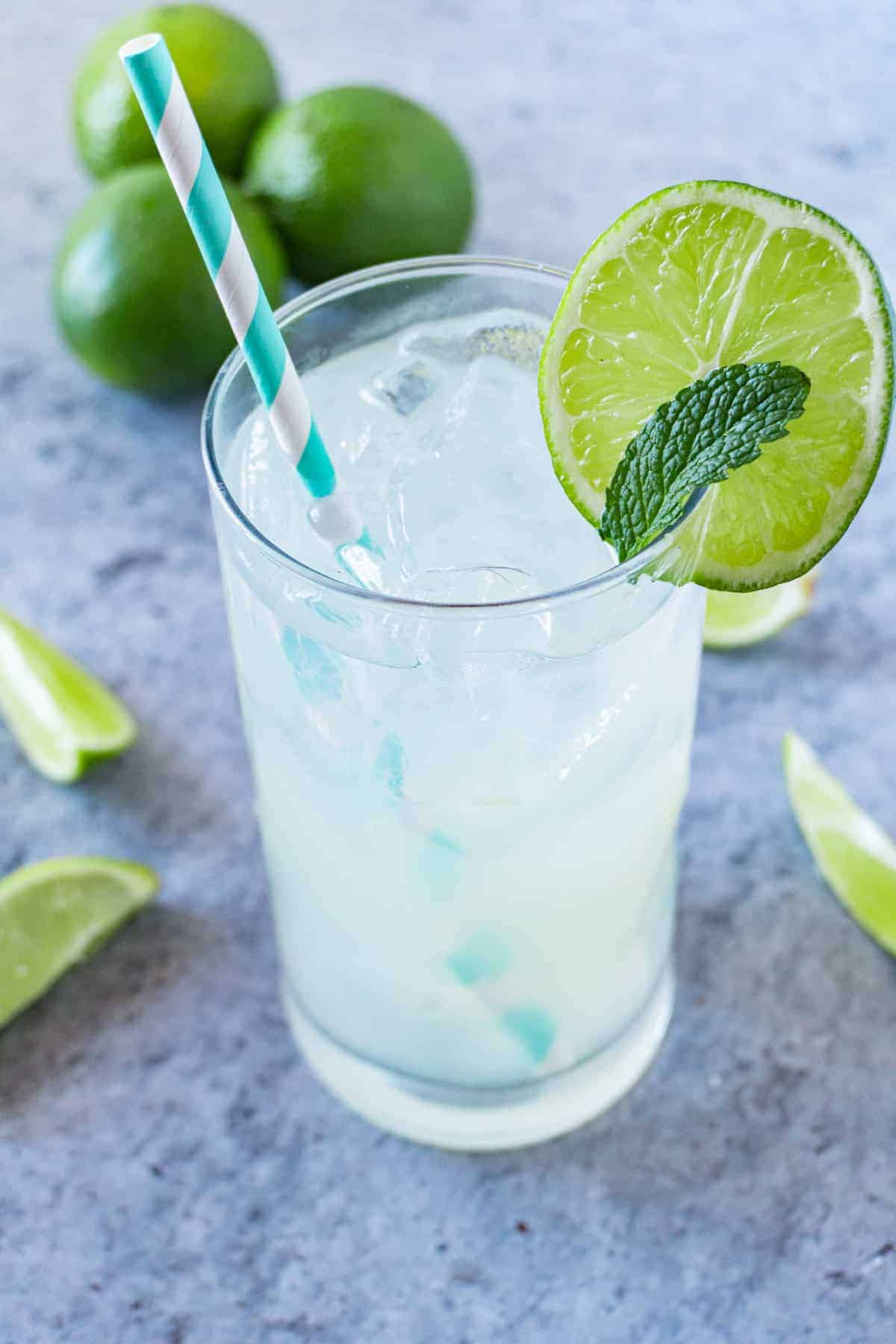 Glass of limeade with lime wedge and straw