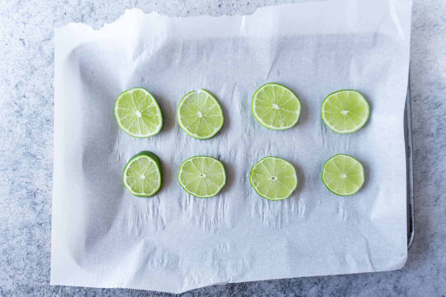 Lime wedges on baking sheet ready to be frozen