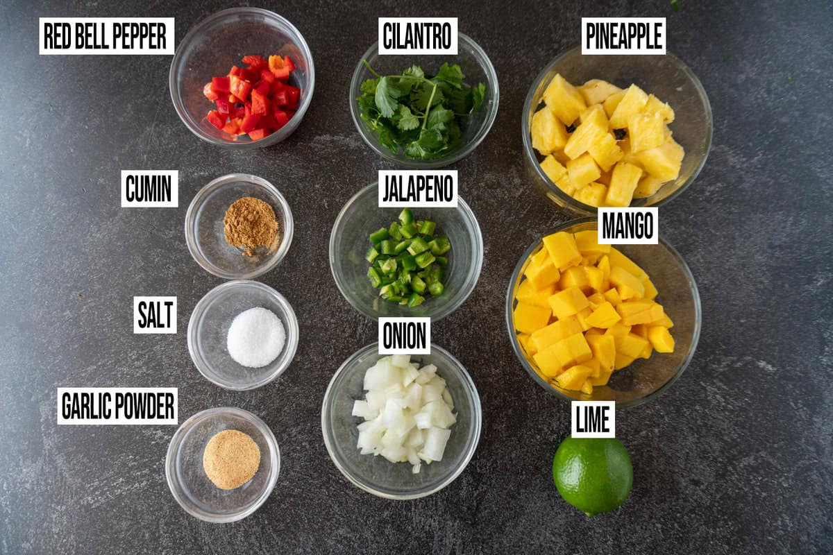 mango salsa ingredients in bowls and labeled.