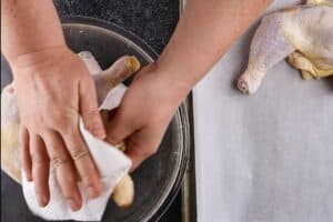 Chicken being patted dry