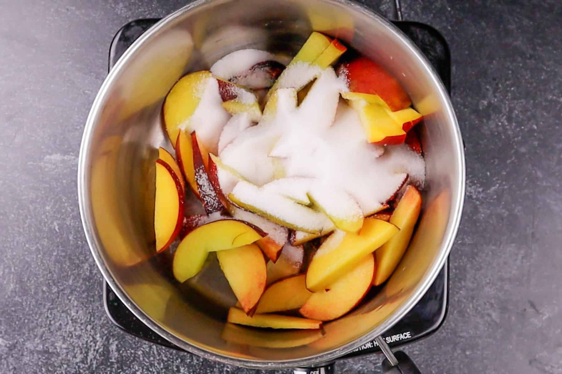 peaches and sugar in sauce pan before heating