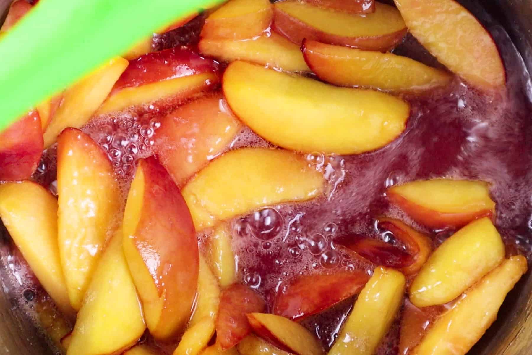 peaches and sugar boiling in sauce pan