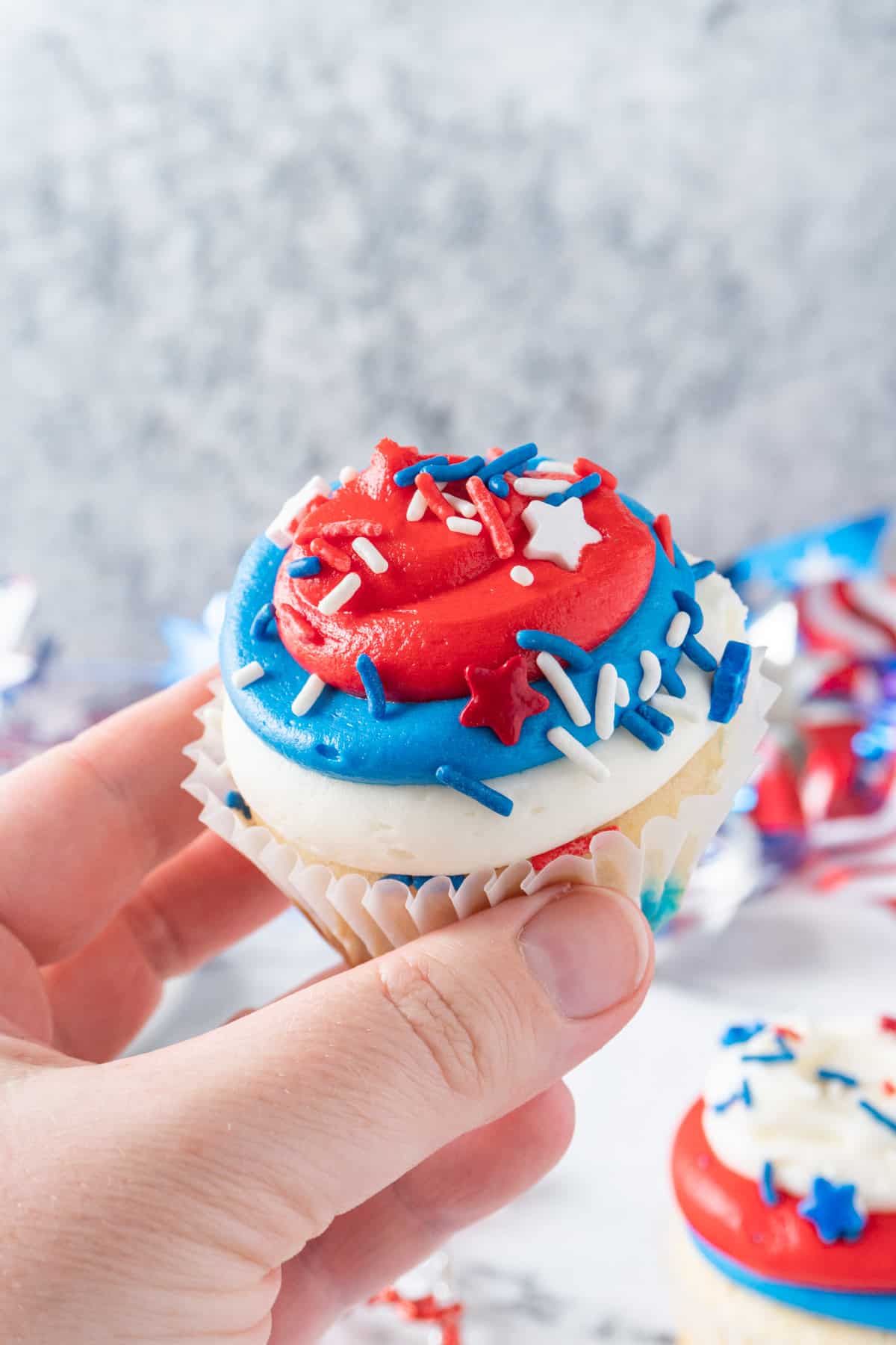 holding a 4th of july cupcake