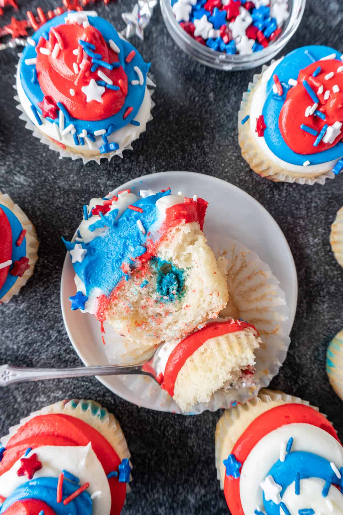 fork cutting through cupcake on plate