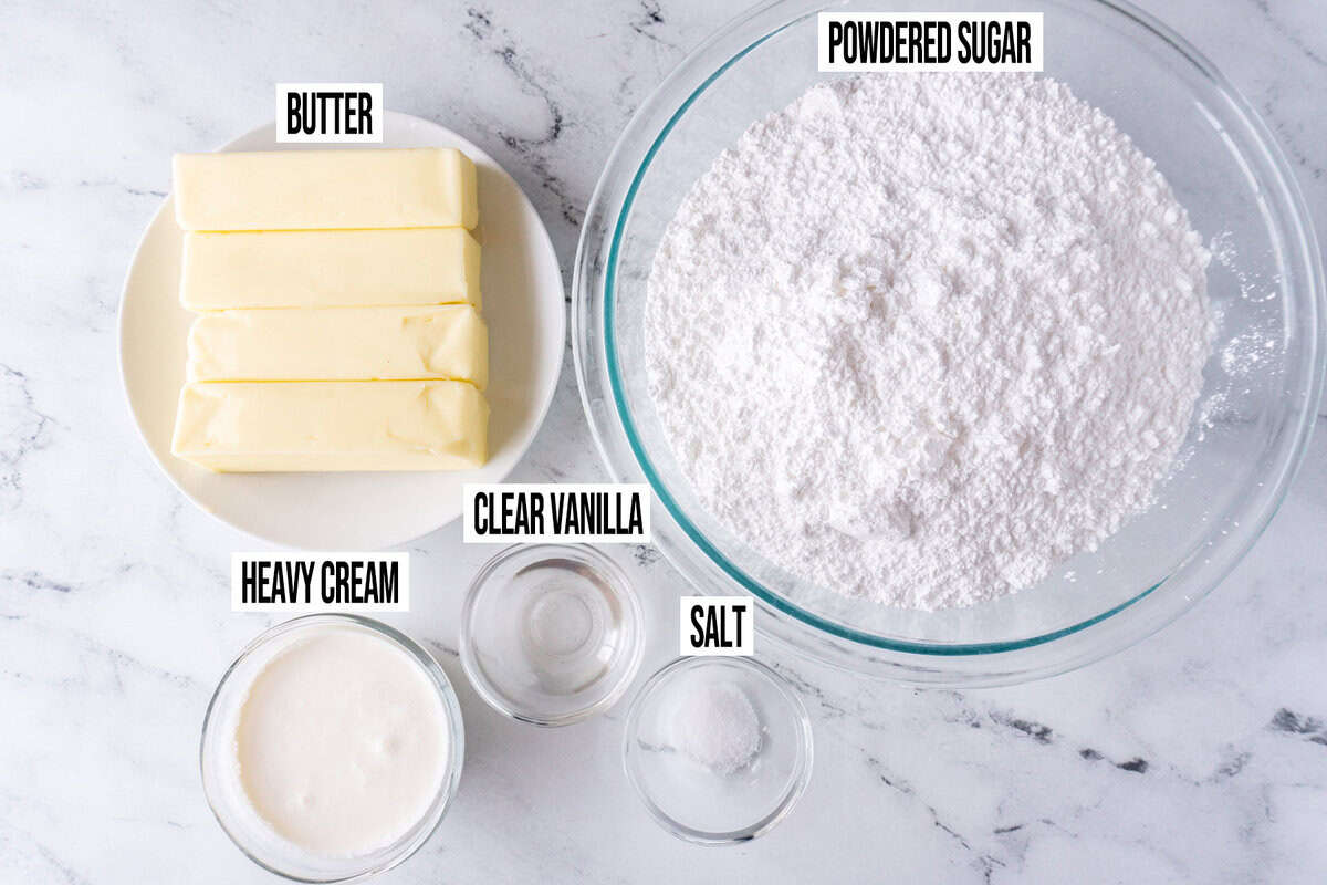 Ingredients for red, white, and blue cupcake frosting in individual bowls and labeled.