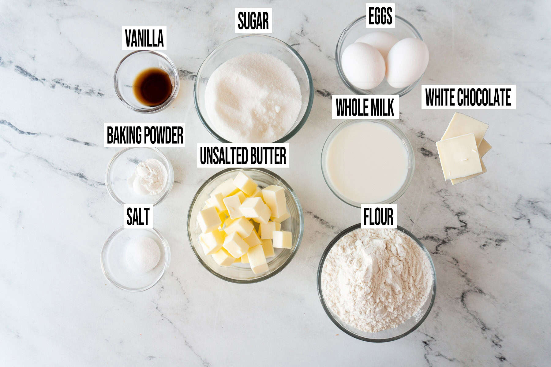 white chocolate cupcake ingredients in individual bowls and labeled.