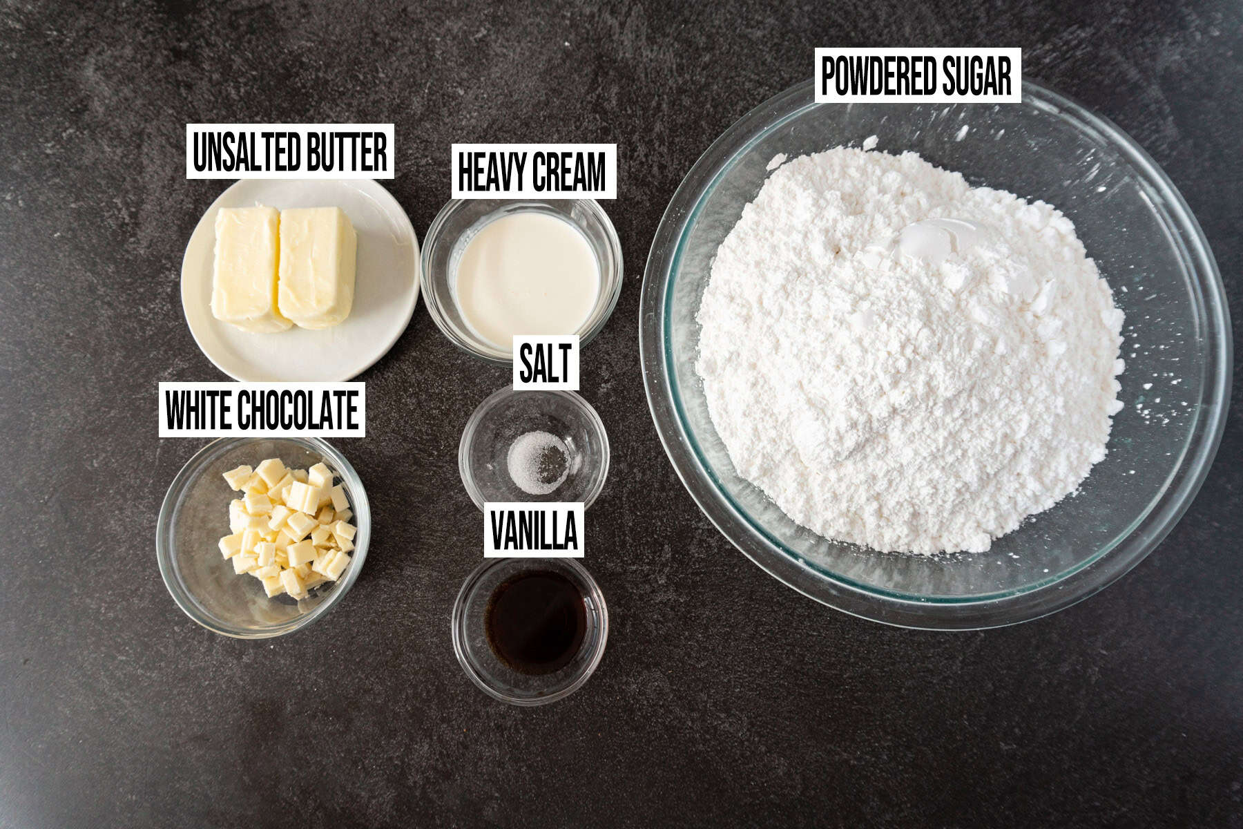 white chocolate frosting ingredients in individual bowls and labeled.
