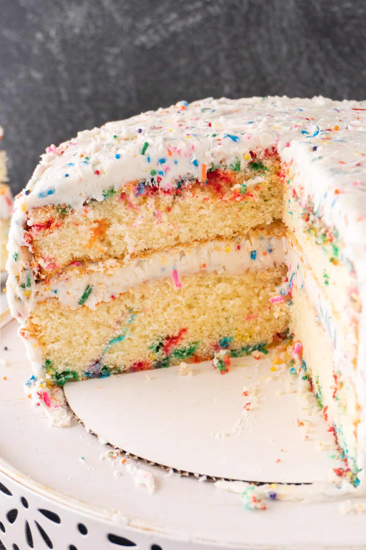 Birthday Cake cut into, showing layers and frosting.