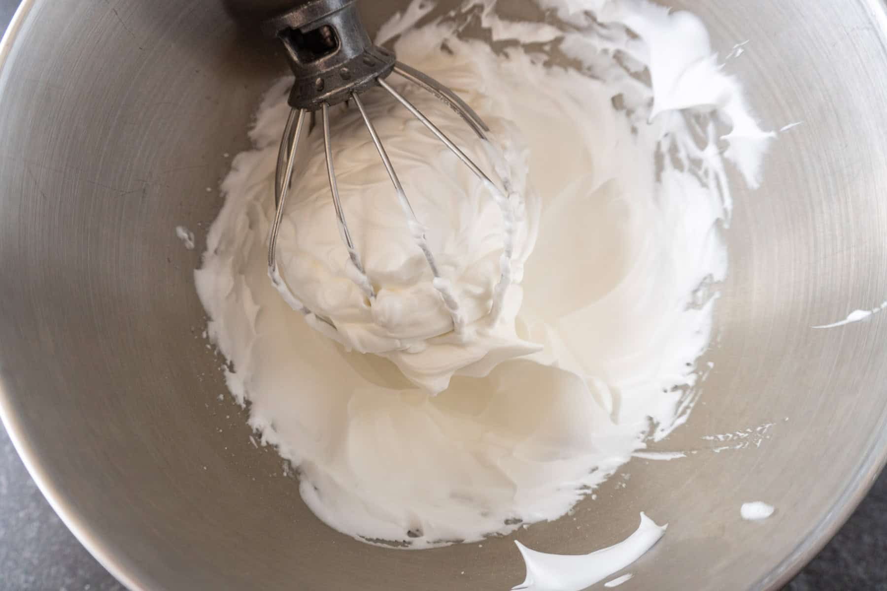 Egg whites whisked to a cloud-like consistency via a stand mixer whisk.