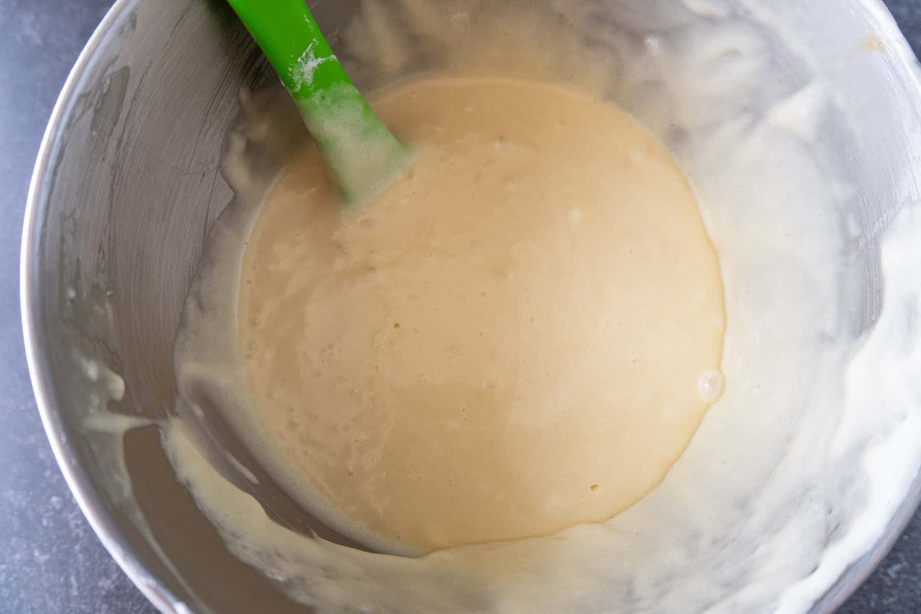 Fluffy cake mix batter of buttermilk and flour mixture combined.