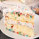 Slice of Birthday Cake on a white plate featured image.