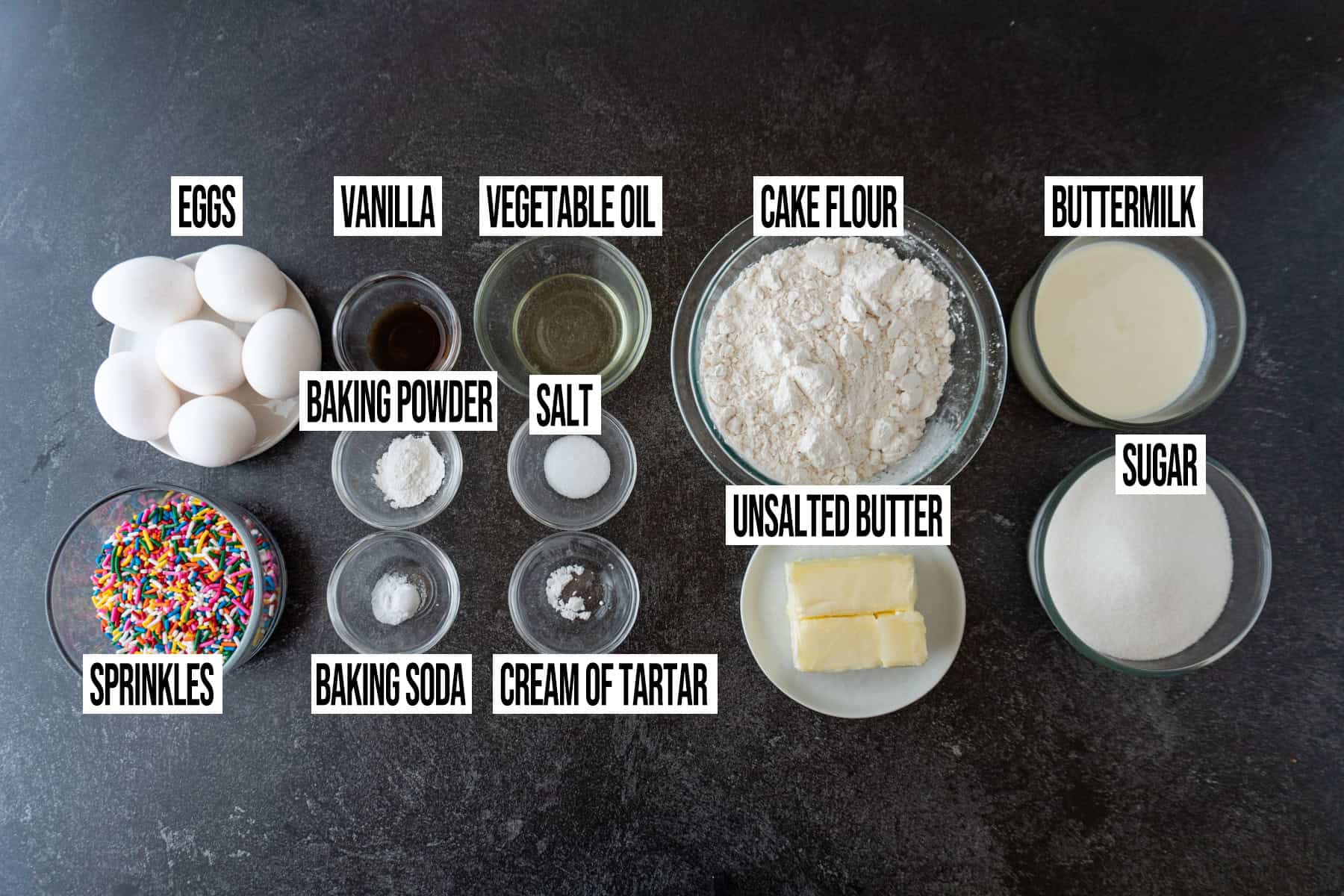 Birthday cake ingredients are in individual bowls and labeled.