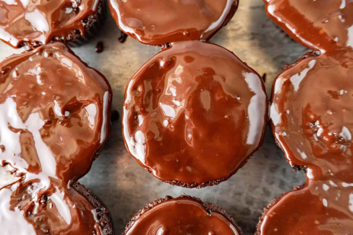 cupcakes with ganache spread on top.