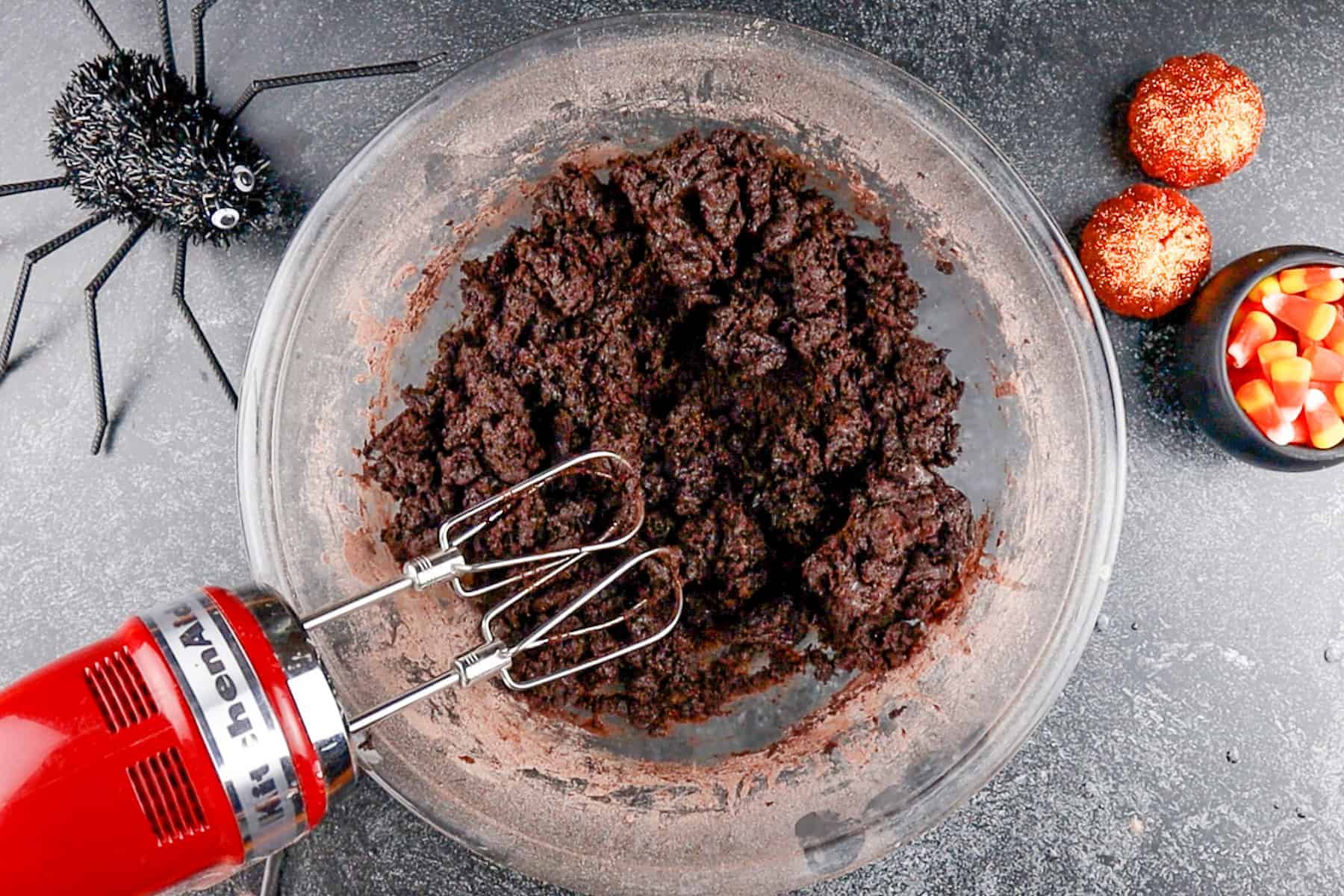 wet and dry ingredients combined to form dough in a glass bowl.