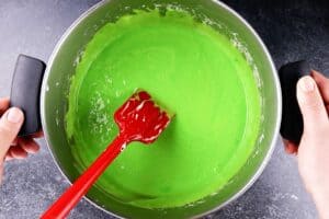 mixing in green food coloring to marshmallow