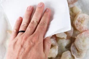 patting shrimp dry