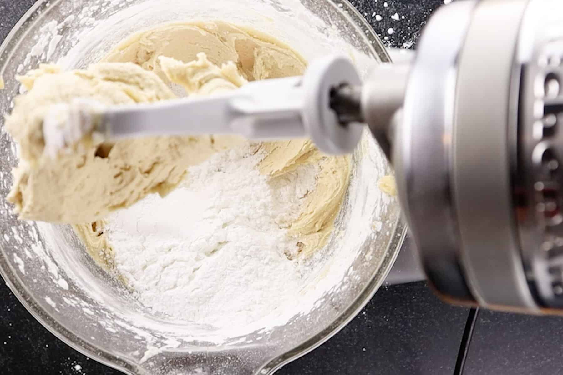 adding powdered sugar to bowl