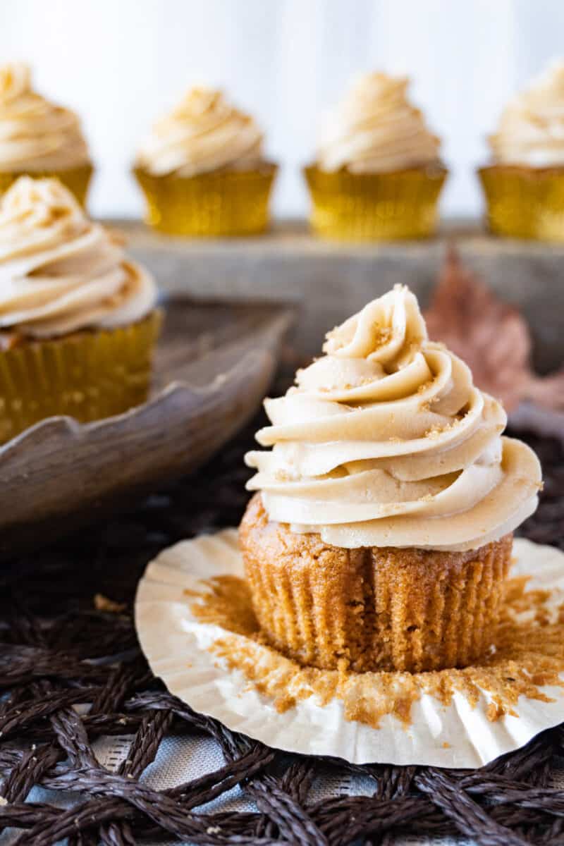 sweet potato cupcake with frosting and cupcakes in background