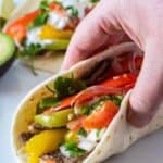 holding a fajita taco