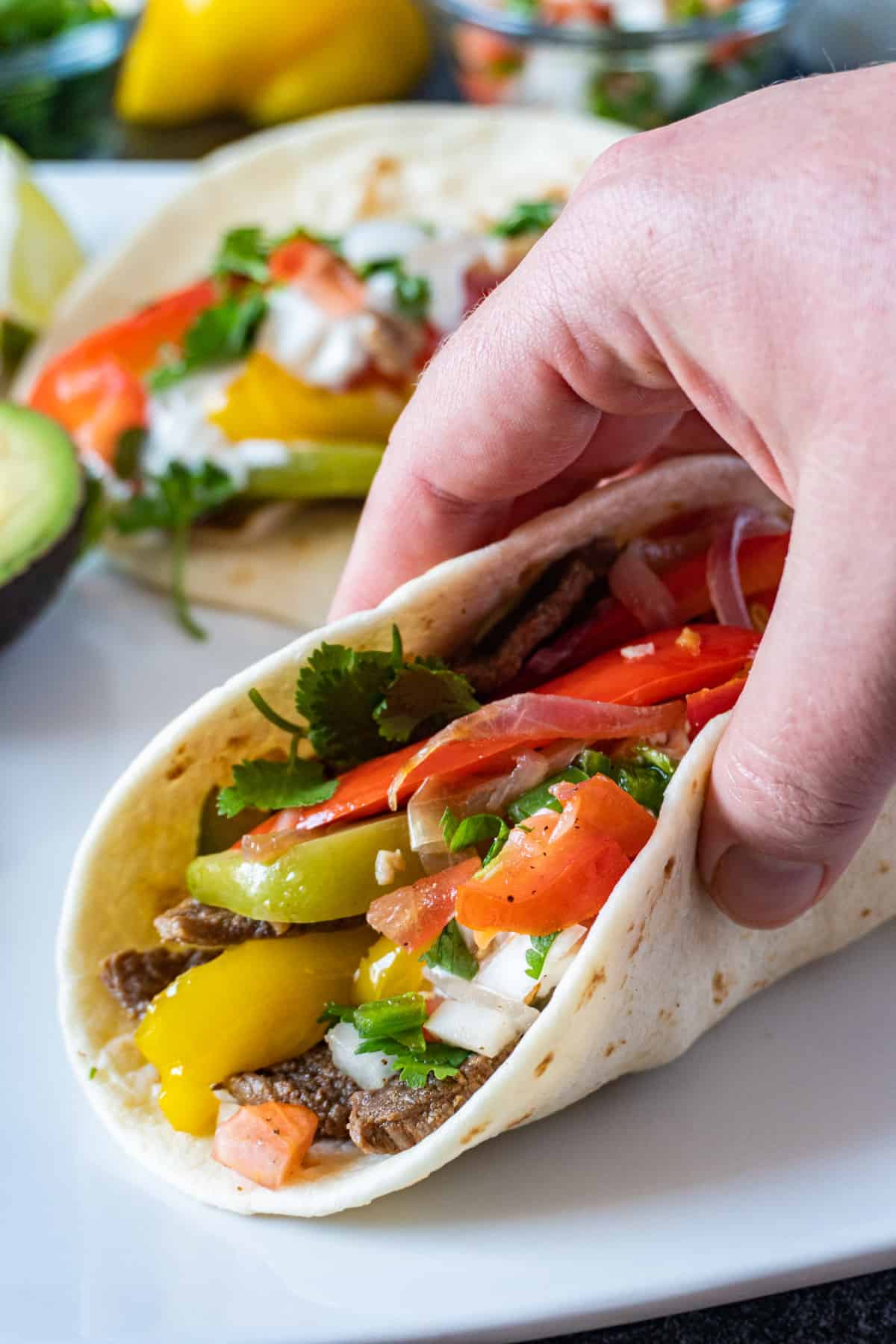 holding a fajita taco