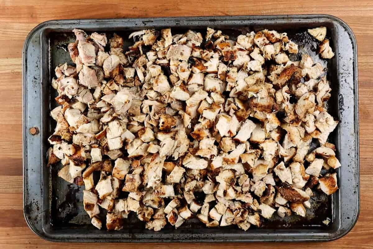 cubed cooked chicken on baking sheet.
