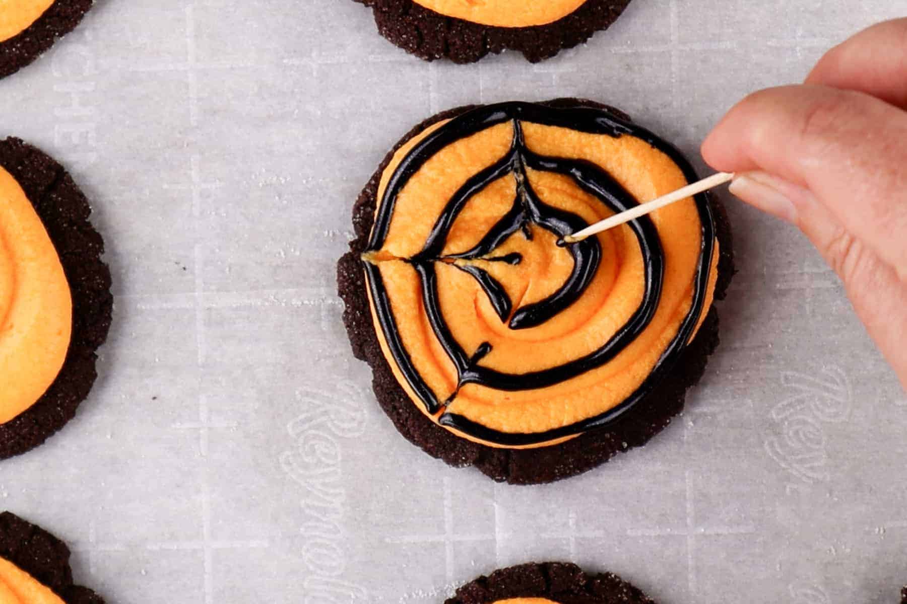 Drag a toothpick through the black circles to create lines and a web effect.