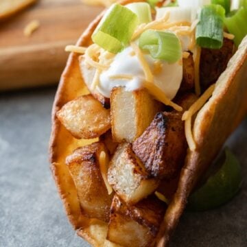 Potato Tacos, A simple and delicious potato taco recipe. Easy to make with only 2 required ingredients, a few spices, and then your favorite toppings! #atablefullofjoy #vegan #vegetarian #potatotacos #tacotuesday #cincodemayo #potato