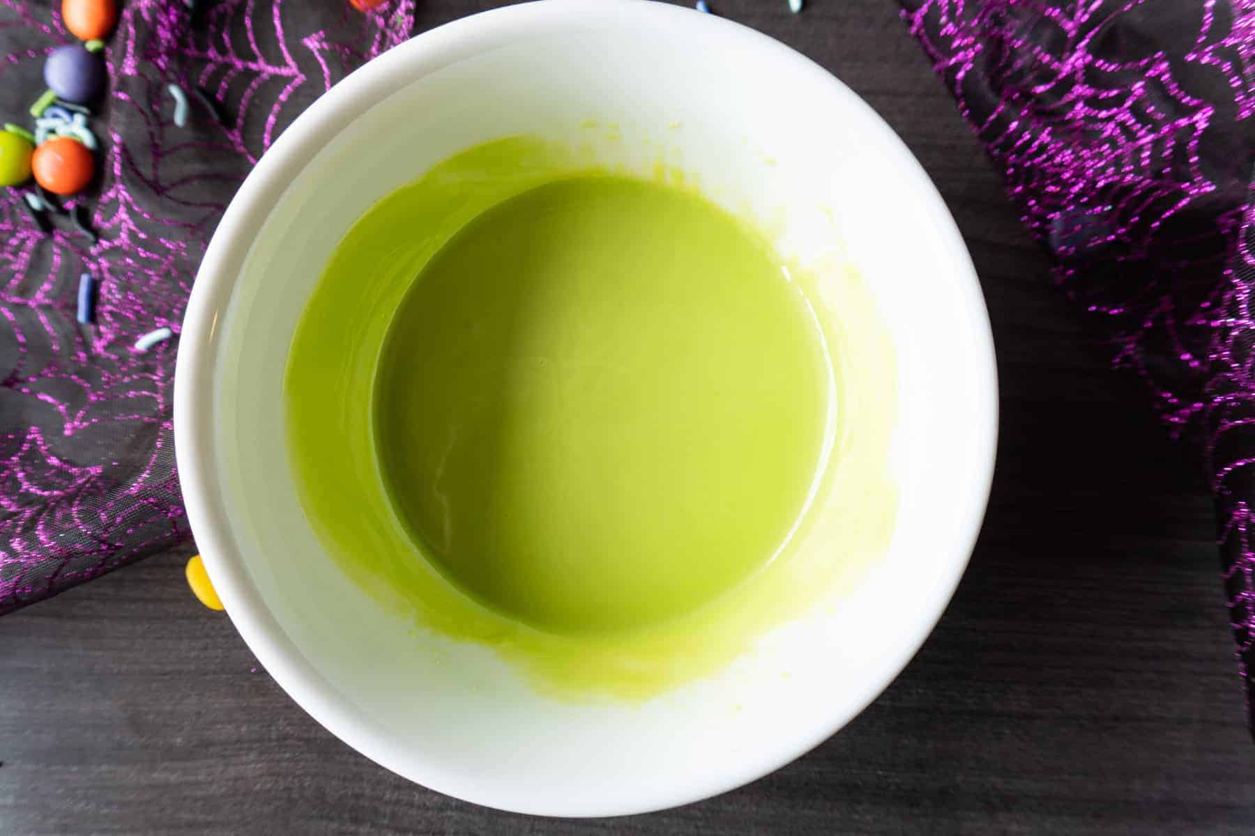 Green Candy Melts Melted in white bowl.