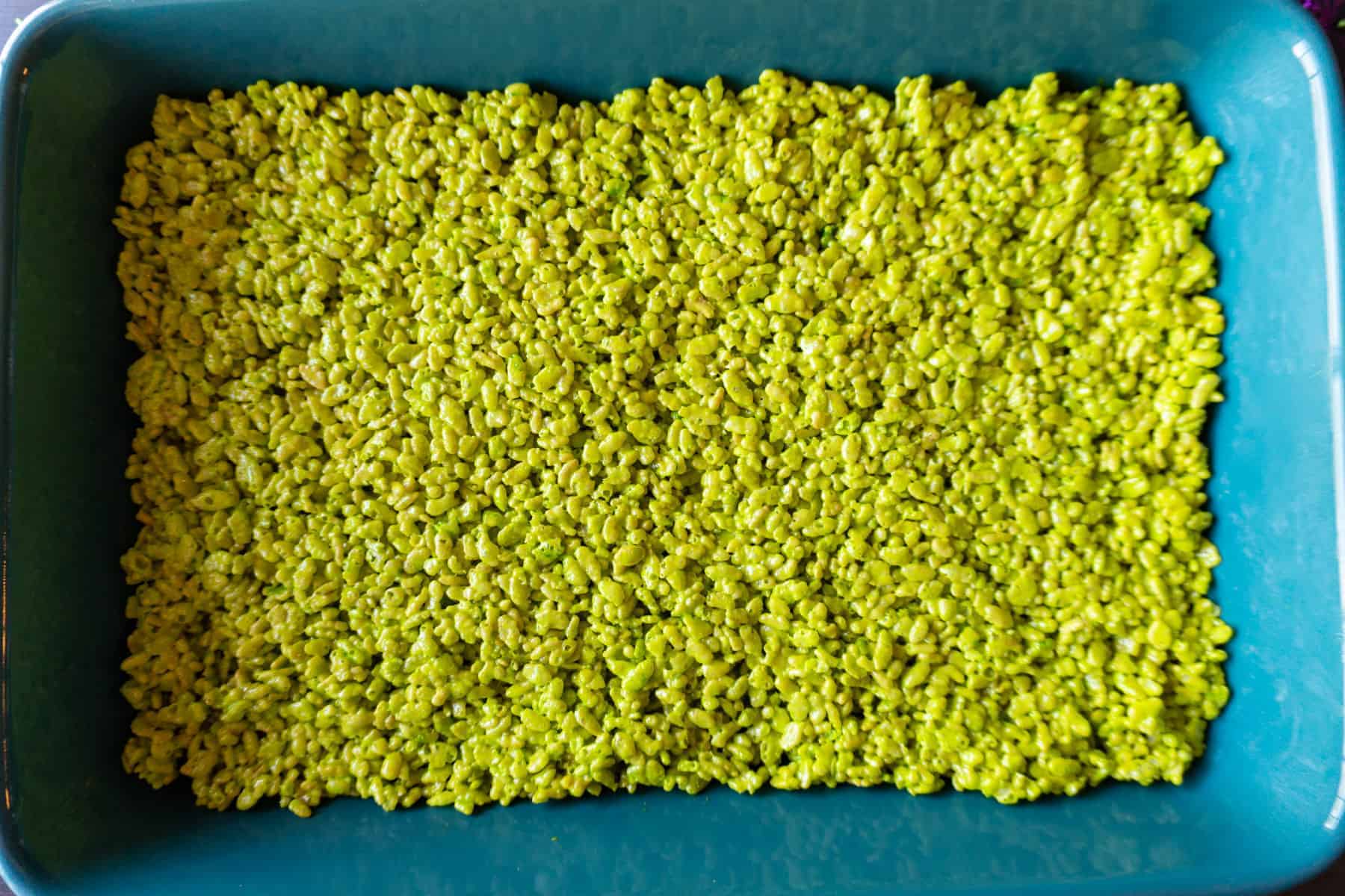 rice krispies dyed neon green cooling in baking dish