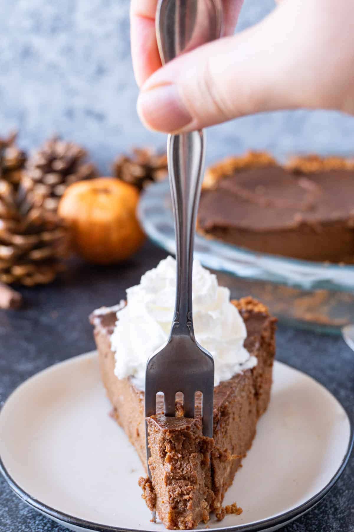 A fork taking a piece out of the Chocolate Pumpkin Pie