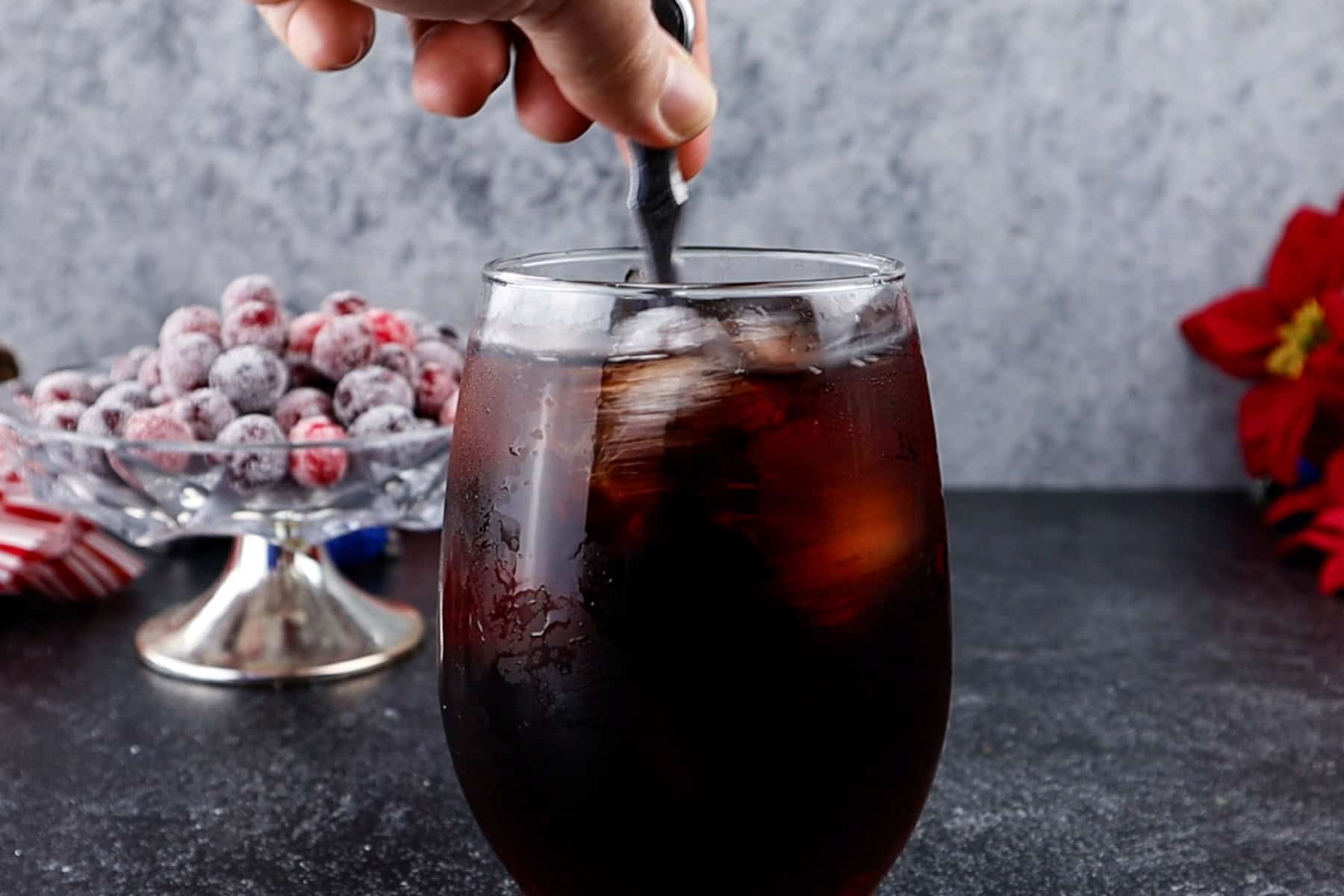 Stirring the Christmas drink after all ingredients have been added.