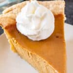 slice of sweet potato pumpkin pie with whipped cream