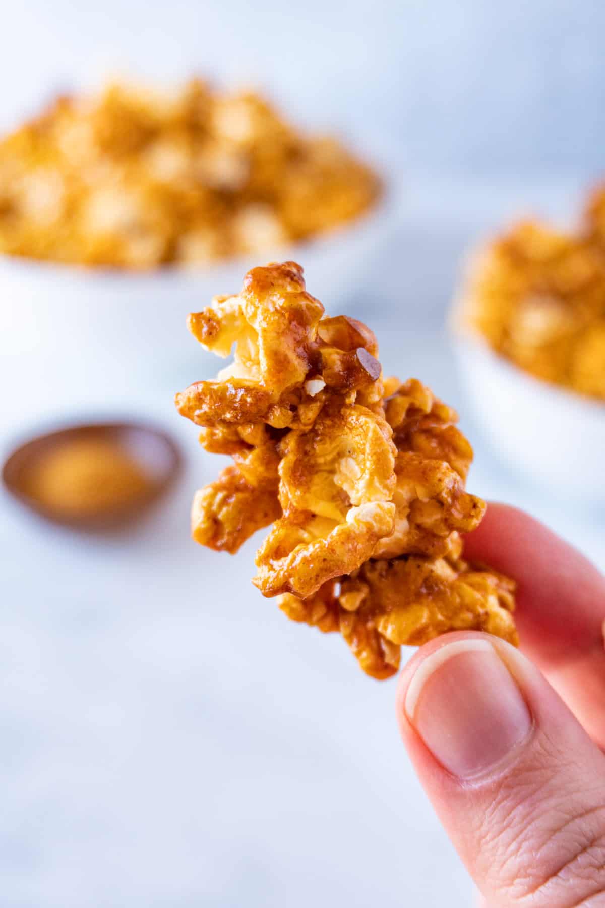 holding a piece of buffalo popcorn